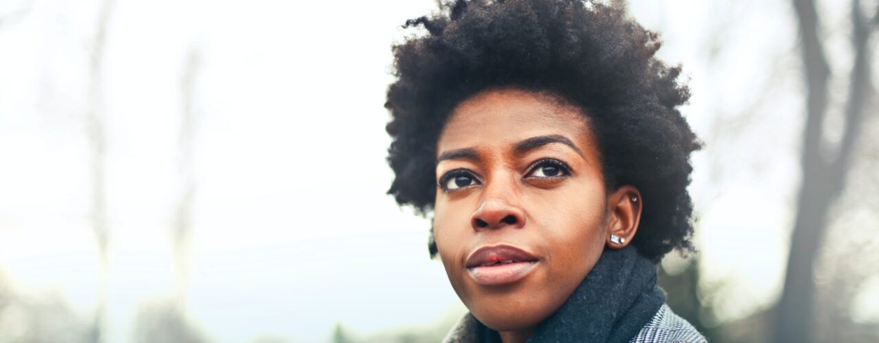 Black woman in suit jacket outdoors
